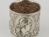 a silver cuff bracelet with an image of a woman in profile