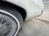 a close up of a tire on a car with a brick wall in the background