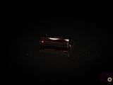a picture of a piece of red garnett in the dark