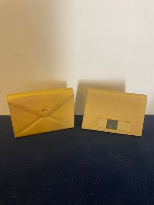 a pair of yellow envelopes sitting on top of a table