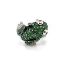 a close up of a ring with green stones on a white background