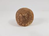 a close up of a stone object on a white surface