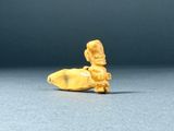 a small figurine of a banana sitting on a table