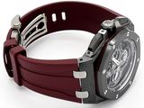 a wrist watch with a red rubber band on a white surface