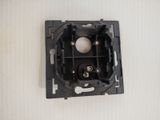 a black electrical outlet with a white ball inside of it