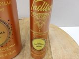 two bottles of body lotion sitting on a wooden board