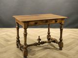 an old wooden table sitting on top of a hard wood floor