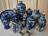 many blue and white vases and cups on the table