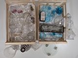 two wooden boxes filled with empty bottles and glassware