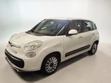 the small white car is parked in a white room