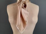 beige silk neck scarf on mannequin torso