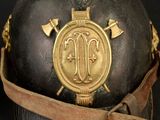 a close up of a helmet with a gold emblem on it