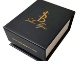 a black box with a gold logo on it