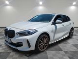 a white bmw x2 parked on a checkered floor