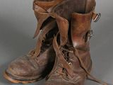 a pair of brown boots with laces on them