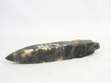 a green stone object with gold on it on a white surface