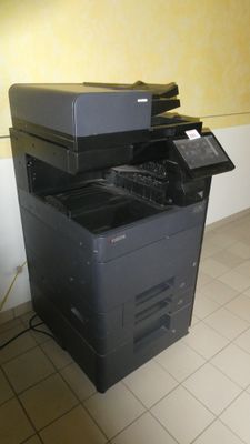 a printer that is sitting on the floor in a room