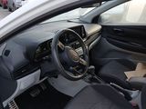 the interior of a white car with black seats and a steering wheel