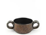 a close up of a cup with handles on a white background