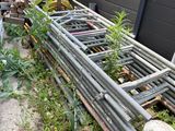a pile of metal pipes and a pile of wood