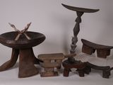 several pieces of african art are displayed on a white surface