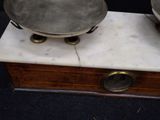 two metal bowls on a marble stand