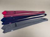 four ties are lined up in a row on a table