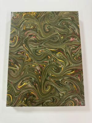 a close up of a piece of art on a white surface