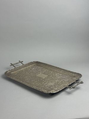 an antique silver tray with handles and handles on a white surface