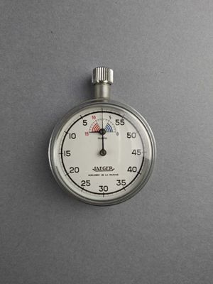 a stopwatch that is on a gray surface