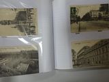 a person holding an open book with pictures of buildings on it