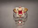 an image of a ring with a ruby stone and diamonds
