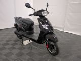 the motor scooter is parked on the floor in the room