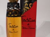 l'image d'un flacon de parfum à côté d'une boîte de parfum