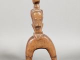 an image of a wooden sculpture of a woman with a hat on her head