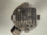a close up of a metal device on a white surface