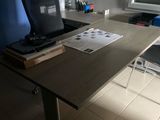 a desk with a laptop and a printer on it