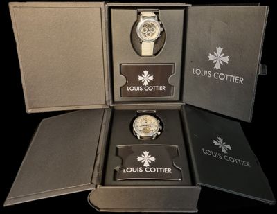 a box with a watch inside of it on a black surface