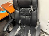 a black office chair that has been left in the room