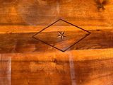a wooden bench with a decorative design on it