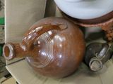 a brown vase sitting on top of a cardboard box