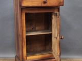 an old wooden cabinet with a glass door on top of a wooden floor