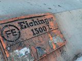 a rusted sign on the side of a building