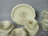 many plates and cups that are sitting on a table