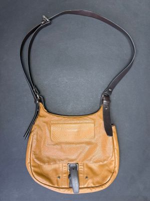 an image of a brown purse on a black surface