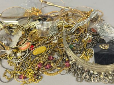 a pile of gold and silver jewelry on a table