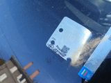 a sticker on the windshield of a car that has a credit card attached to it