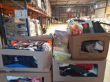several boxes of clothing are stacked on top of each other in a warehouse