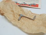 a piece of paper that has a small metal object on it