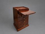 a small wooden desk with drawers and a drawer on top of it